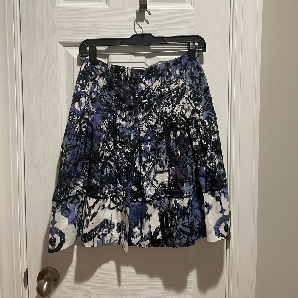 Go with style in this cute Tahari abstract skirt with pleats and embroidery